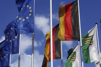 The flags of Europe, Germany and Saxony in front of the congress centre in Dresden