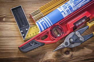 Construction level tin snips engineering drawing wooden meter square ruler on wood board