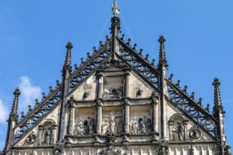 Above the frieze, larger-than-life stone figures of the twelve apostles, saints and benefactors