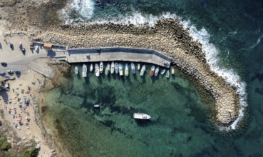 Aerial drone view of fishing boats moored at the harbor. moored at breakwater. Peyia, Cyprus