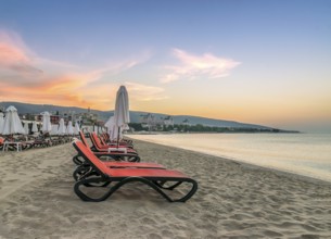 Chairs and umbrellas on a beautiful beach at sunrise in Sunny Beach on the Black Sea coast of