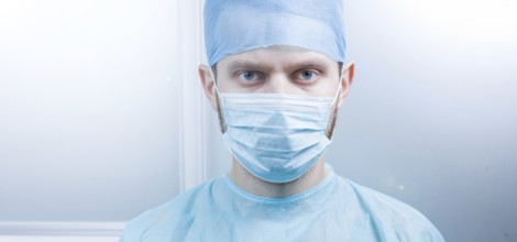Doctor looking directly at the camera in a clean medical environment