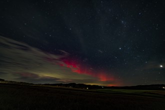 Night sky with auroras over a dark landscape, Bogen, Lower Bavaria