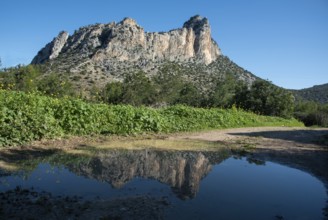 Famous Pentadaktylos rocky mountain peaks reflected on water in Kerynia town in Cyprus late in the