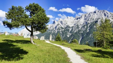 Rock garden on the hiking trail from Lautersee to Mittenwald with Karwendel mountains and huts