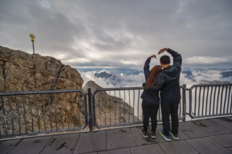Zugspitze Peak top of Germany and Alps mountain range with love couple tourist, Garmisch