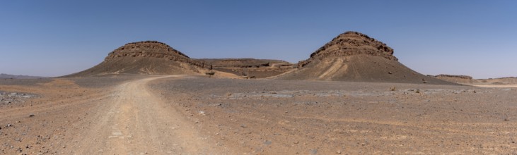 Iconic horseshoe mountain Gara Medouar in the desert near Merzouga, known for different film sets,