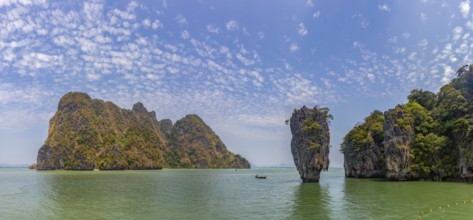 A colorful picture of the beautiful landscape of the James Bond Island and its iconic islet