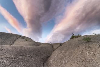 Colored clouds above a clayey land of Provence in the Drome. France