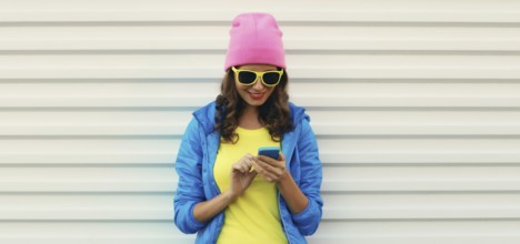 Happy smiling modern young woman with phone, teenage girl holding smartphone looking at device in