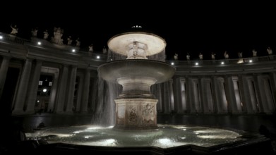 An illuminated night view of a flowing fountain surrounded by columns, Fontana del Bernini, St.
