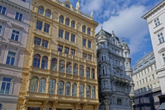 Ornate historical buildings on a busy street in Vienna under a clear blue sky, Vienna, Austria