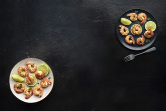 Shrimps, overhead flat lay banner with copy space. Cooked shrimp with lime, shot from the top on a
