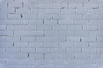 Background consisting of a wall of grey painted bricks