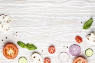 Food cooking background: arranged fresh ingredients, basil, cherry tomatoes, mushrooms, cut