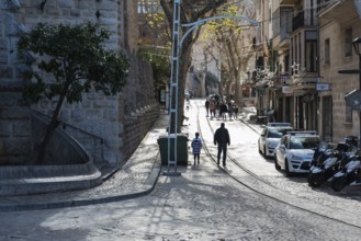 Soller, Spain, 12 25 2017: main street with a few people and cars parked