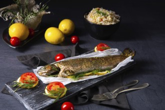 Baked trout with herb filling and tomatoes