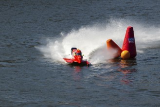 PESO DA REGUA, PORTUGAL - SEPTEMBER 15, 2024: Red Powerboat Makes Sharp Turn with Splashes of Water