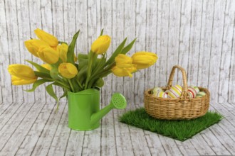 Yellow tulips with Easter eggs on a textured background