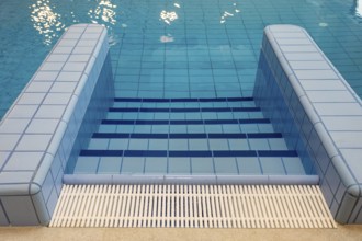 Tranquil pool steps gently leading into the refreshing, clear blue water, perfect for peaceful