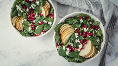 Fresh salad with baby spinach, pear, pomegranate and cottage cheese. Two bowls with delicious