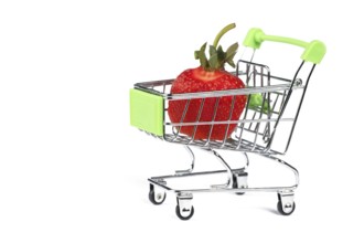 Supermarket trolley with strawberries on a white background. Sale of berries