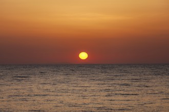 Sunrise over the sea, view from Kamari, island of Santorini, Cyclades, Greece