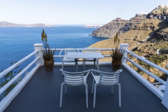 Table and armchair, viewpoint on the crater rim, Fira, Santorini Island, Cyclades, Greece