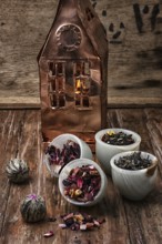 Tea leaves on the background of the house foil on wooden surface.photo tinted