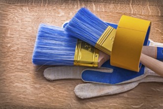 Set of protective gloves with paint brushes in duct tape maintenance concept