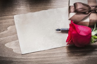 Red rose giftbox sheet of paper fountain pen holiday concept