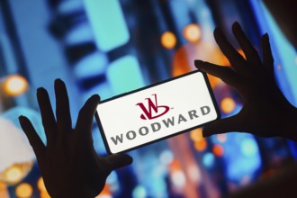In this photo illustration, the Woodward logo is displayed on a smartphone screen