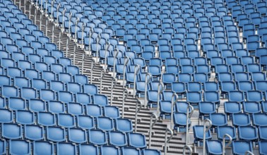 Blue plastic empty stadium or stage chairs in a row