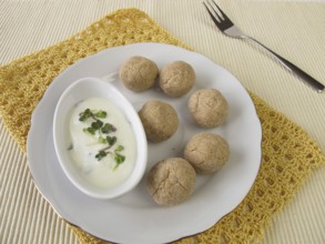 Tsampa balls with yoghurt and radish sprouts