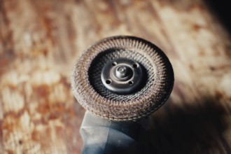Detailed view of an angle grinder on a wooden surface