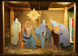Snowy winter morning and New Year's electrical decorations in the city center, Nativity scene near