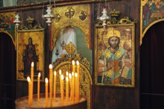 The interior of the church. Icons, chandelier, candles in a small Christian Orthodox church in