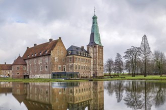 Water castle Raesfeld in Muensterland, North Rhine-Westphalia, Germany. View with lake