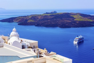 Santorini, Greece iconic view of white houses, church dome, caldera, volcano island and sea