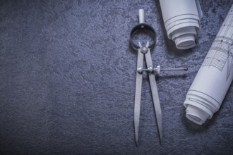 Construction drawings pair of compasses on black background maintenance concept