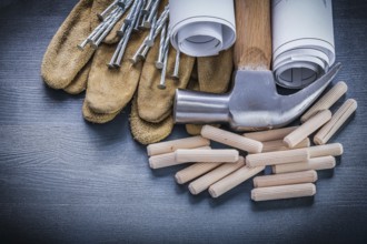 Dowels hammer blueprints nails gloves