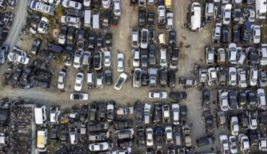 Aerial view of junkyard with discarded broken cars. Recycling of old vehicles
