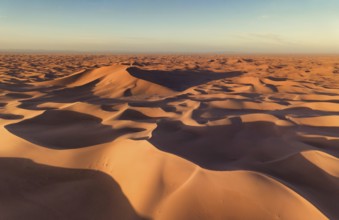 Aerial view on big sand dunes, landscape in Sahara desert at sunrise
