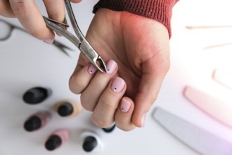 Woman hands, nail polish, manicure tools table top view flat lay. How to do manicure at home