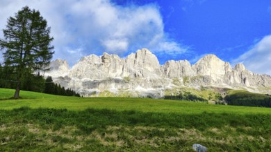 Val di Fassa with a view of the Dolomites (Catinaccio) and blue sky