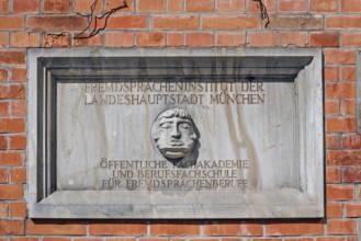 Information sign with Janus head, Foreign Language Institute of the state capital in Amalienstraße,