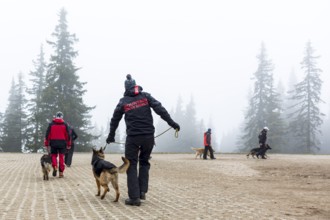 Sofia, Bulgaria - April 20, 2016: Men and their dogs at the search and rescue team at Bulgarian Red