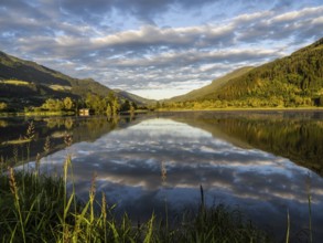 Evening light, forest landscape and clouds reflected in the lake, Gaishorner See, near Gaishorn am