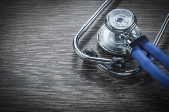 Stethoscope on vintage wooden board