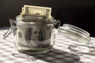 Dollar banknote saving money in glass jar. Consumption and economy Collecting money. Tips.